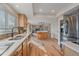 Open kitchen design with wood cabinets, stainless steel refrigerator and an island at 18263 E Mansfield Ave, Aurora, CO 80013