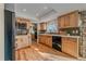 Well-lit kitchen with wooden cabinets, stainless steel appliances and undermount sink at 18263 E Mansfield Ave, Aurora, CO 80013