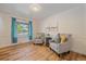 Cozy living room with wood floors, two chairs, side table, and natural light at 18263 E Mansfield Ave, Aurora, CO 80013