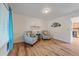 Bright living room featuring hardwood floors, matching armchairs, and natural light at 18263 E Mansfield Ave, Aurora, CO 80013