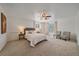 Spacious bedroom with carpet, ceiling fan, and seating area with bright windows at 18263 E Mansfield Ave, Aurora, CO 80013