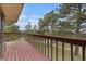 Wooden deck offering stunning views of the surrounding landscape and lush trees at 22453 Hillcrest Cir, Golden, CO 80401