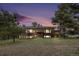 Stunning two-story home with beautiful architecture surrounded by lush landscaping and a colorful sky at 22453 Hillcrest Cir, Golden, CO 80401