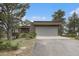 View of the garage, and driveway of this home with beautiful landscaping at 22453 Hillcrest Cir, Golden, CO 80401
