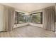 Open living room with big bay windows, and classic curtains at 22453 Hillcrest Cir, Golden, CO 80401
