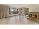 Bright living room featuring a cozy fireplace and scenic views from multiple windows and balcony access at 22453 Hillcrest Cir, Golden, CO 80401