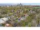 An aerial view of a tree-lined neighborhood in Denver, with the city skyline in the distance at 635 N Williams St, Denver, CO 80218