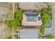 Bird's eye view of a home with a tile roof, solar panels, and mature trees at 635 N Williams St, Denver, CO 80218
