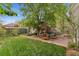 Spacious backyard with a patio, comfortable seating, and a lush green lawn at 635 N Williams St, Denver, CO 80218