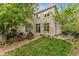 Beautiful backyard with a patio, outdoor seating, green lawn, and mature trees at 635 N Williams St, Denver, CO 80218