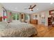 Bright bedroom features hardwood floors, a ceiling fan, many windows, and ensuite bathroom access at 635 N Williams St, Denver, CO 80218