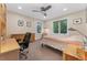 Bedroom with neutral paint, ceiling fan, large window, and desk with rolling office chair at 635 N Williams St, Denver, CO 80218