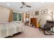 Bedroom with ceiling fan, large window, an office desk, a wooden bookshelf and lounge chair at 635 N Williams St, Denver, CO 80218