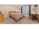 Comfortable bedroom featuring a large window, carpeted floors, and a wooden desk with chair at 635 N Williams St, Denver, CO 80218