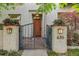 Elegant home entrance featuring a gated entryway with lovely planters leading to a solid wood front door at 635 N Williams St, Denver, CO 80218