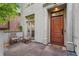 Inviting front entrance with seating area and a classic wooden door with stone trim at 635 N Williams St, Denver, CO 80218