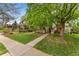 Charming home with a well-maintained front lawn, mature trees, and a walkway at 635 N Williams St, Denver, CO 80218