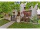 Charming home with a stucco exterior, well-manicured lawn, beautiful landscaping, and inviting front gate at 635 N Williams St, Denver, CO 80218