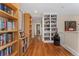 Well-lit hallway features built-in bookshelves and hardwood floors at 635 N Williams St, Denver, CO 80218