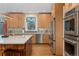 Modern kitchen featuring stainless steel appliances, a center island, and stylish backsplash at 635 N Williams St, Denver, CO 80218