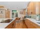 Bright kitchen with hardwood floors, dining nook, and custom cabinetry and counters at 635 N Williams St, Denver, CO 80218