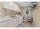 Functional laundry room with sink, white cabinets, counter space, washing machine, and dryer at 635 N Williams St, Denver, CO 80218