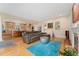 Inviting living room featuring a leather sofa, open kitchen, and hardwood floors at 635 N Williams St, Denver, CO 80218