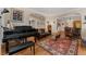 Inviting living room features a piano, hardwood floors, and an open floor plan at 635 N Williams St, Denver, CO 80218