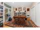 Well-lit office with a built-in bookcase, hardwood floors, and large window at 635 N Williams St, Denver, CO 80218