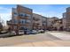 Modern condo building featuring balconies, assigned parking, and an attractive neutral color palette at 5677 S Park Pl # A110, Greenwood Village, CO 80111