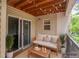 Relaxing balcony with a cushioned bench, string lights, and a tranquil outdoor setting at 12208 W Dorado Pl # 207, Littleton, CO 80127