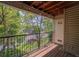 Outdoor balcony featuring wooden deck, black metal rails, and peaceful neighborhood views at 12208 W Dorado Pl # 207, Littleton, CO 80127