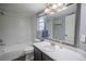 Clean bathroom features a tub and shower, sink, mirror and good lighting at 12208 W Dorado Pl # 207, Littleton, CO 80127