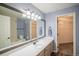 Bathroom with a large mirror, vanity, and a separate room for the toilet and shower/tub at 12208 W Dorado Pl # 207, Littleton, CO 80127