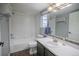 Functional bathroom featuring a shower-tub combo, modern fixtures, and vanity with good lighting at 12208 W Dorado Pl # 207, Littleton, CO 80127