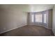Inviting bedroom with neutral tones, plush carpet, and large windows offering plenty of natural light at 12208 W Dorado Pl # 207, Littleton, CO 80127