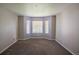 Bright bedroom features a large bay window and cozy neutral carpet at 12208 W Dorado Pl # 207, Littleton, CO 80127