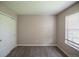 Cozy bedroom features neutral colors and ample natural light from a large window at 12208 W Dorado Pl # 207, Littleton, CO 80127