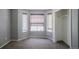 Empty bedroom featuring a bay window with blinds and an open closet perfect for storage solutions at 12208 W Dorado Pl # 207, Littleton, CO 80127