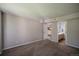 Spacious bedroom featuring neutral tones, carpet, and a view to the bathroom and kitchen at 12208 W Dorado Pl # 207, Littleton, CO 80127