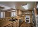 The kitchen features stainless appliances, tile backsplash, and open serving area at 12208 W Dorado Pl # 207, Littleton, CO 80127