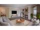 Inviting living room featuring a cozy fireplace, built-in shelving, and comfortable seating arrangement at 12208 W Dorado Pl # 207, Littleton, CO 80127