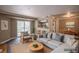 Bright living room featuring a large balcony, wooden floors, and an open kitchen layout at 12208 W Dorado Pl # 207, Littleton, CO 80127