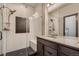 Modern bathroom featuring a glass-enclosed shower with subway tile and a granite vanity at 6792 Canosa St, Denver, CO 80221