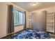 Cozy bedroom with a comfortable murphy bed, a bright window, and a stylish blue rug at 6792 Canosa St, Denver, CO 80221