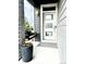 Inviting front porch featuring a modern door, hanging chair, and a large pot with colorful flowers at 6792 Canosa St, Denver, CO 80221