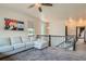 Upstairs living room with large windows, plush seating, and a ceiling fan at 6792 Canosa St, Denver, CO 80221