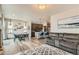 Open concept living room and kitchen featuring stainless steel appliances and hardwood floors at 6792 Canosa St, Denver, CO 80221