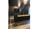 Modern living room featuring dark walls, hardwood floors, and a stylish console table behind the couch at 6792 Canosa St, Denver, CO 80221
