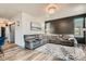 Open living area with a large gray sectional couch and decorative black wall at 6792 Canosa St, Denver, CO 80221